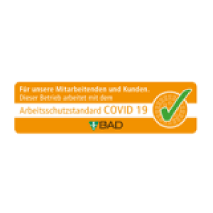 Orange safety certification badge with a green checkmark indicating compliance with the COVID-19 occupational safety standard from BAD.