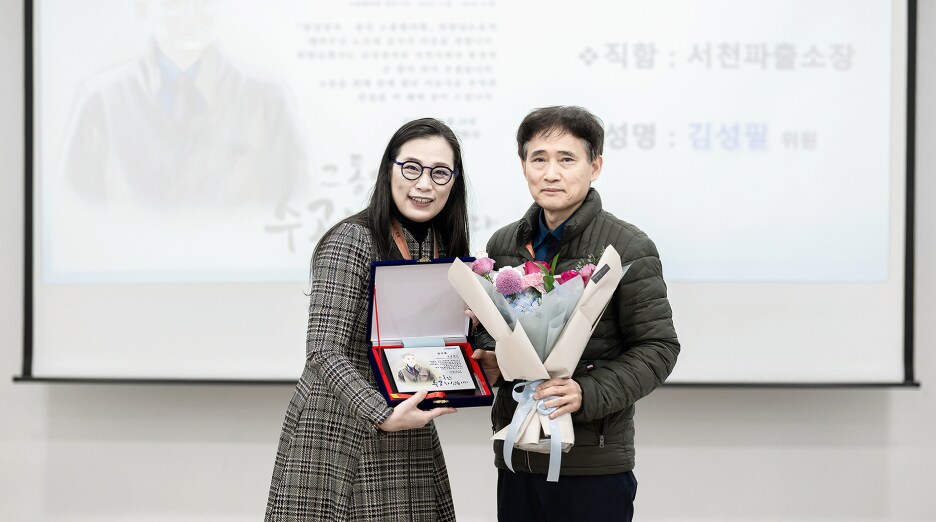 감사패와 꽃다발을 들고 있는 前 서천파출소장 김성필 위원과 고정미 센터장