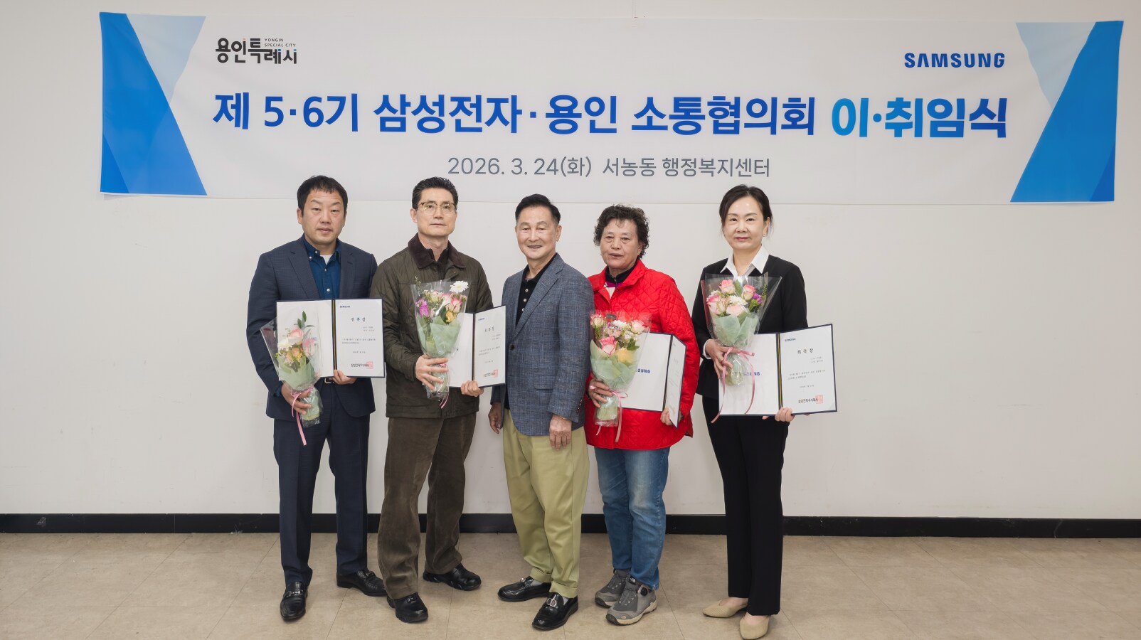 제6기 신임 위원들이 취임을 기념하여 꽃다발과 위촉장을 들고 있는 모습