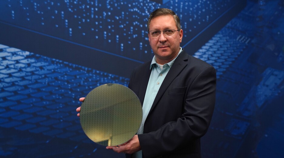 Rafael Lainez holding a 12-inch wafer at Samsung Austin Semiconductor.