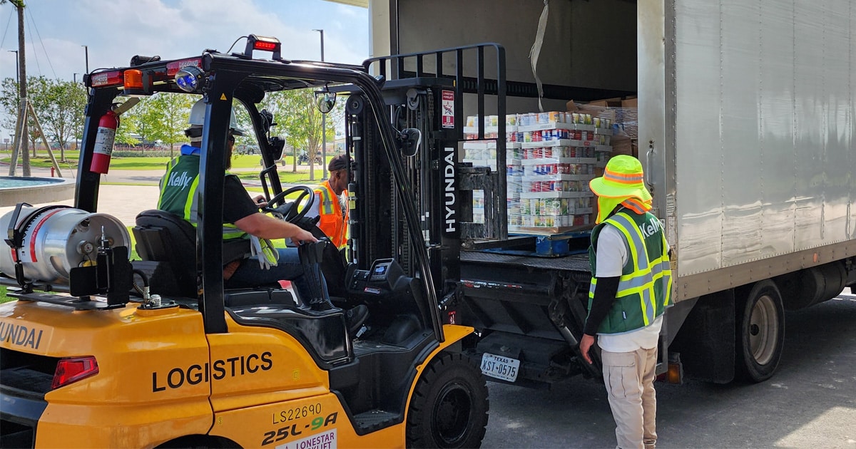 Crews helping load the donated canned goods into Shepherd's Heart box truck.