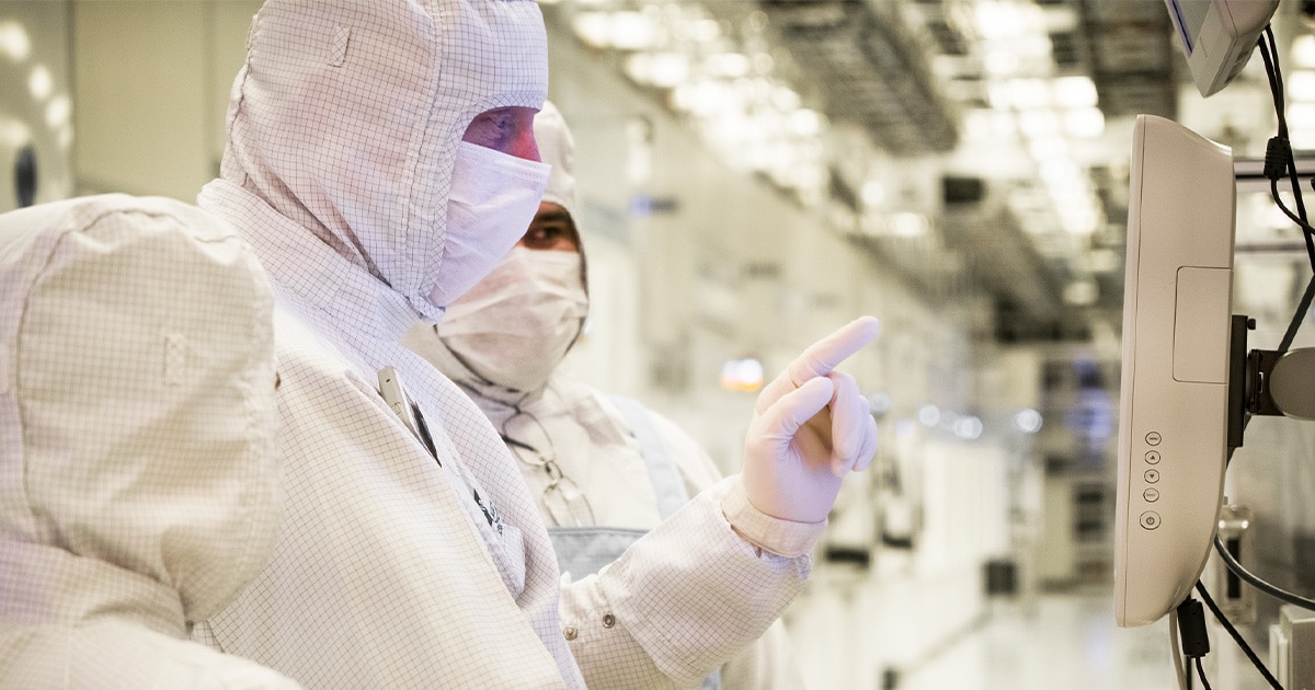 Employees working inside the fab cleanroom.