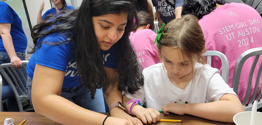 Engineer Khushi Shah helping a child with a circuit