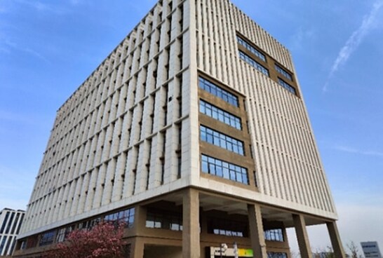 An exterior view of the Xi’an Lab building, marked by repetitive vertical paneling and large glass windows.