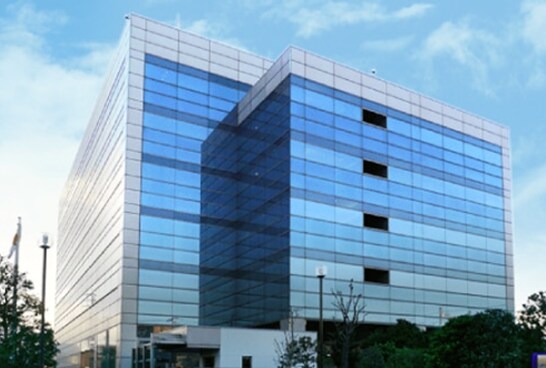 The Yokohama research facility, featuring a modern glass curtain wall design with reflective surfaces.