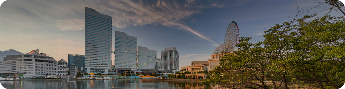 The Samsung Austin Campus in Texas features a mirrored glass façade, a central fountain, and national and state flags at the front.