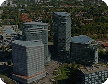 Aerial view of a Samsung office complex featuring multiple glass high-rise buildings surrounded by greenery and urban infrastructure.
