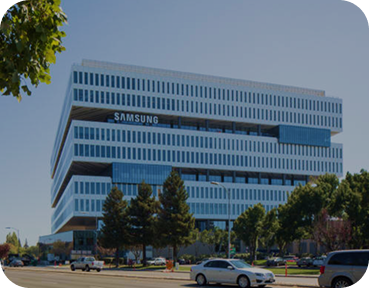 Samsung corporate building in Silicon Valley, featuring a sleek stacked design and expansive windows on a sunny day.