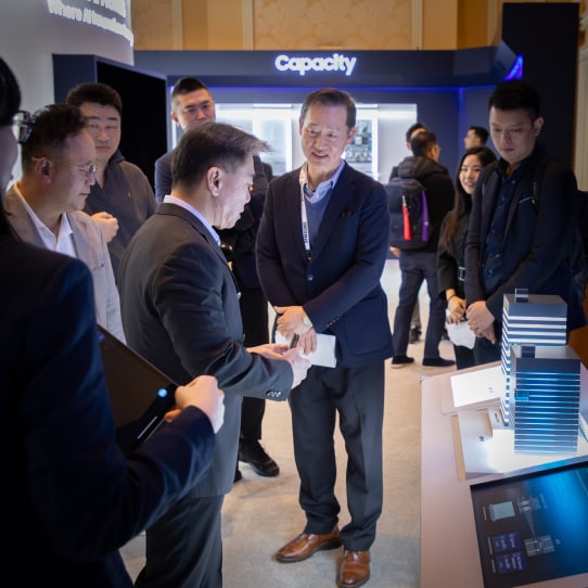 A group of professionals interacts with Samsung experts at CES 2025.