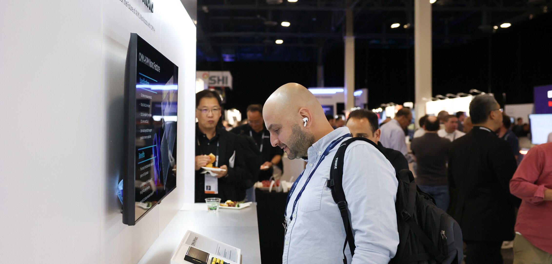 An attendee closely examining a display at the Samsung Semiconductor booth during Dell Technologies World 2024.