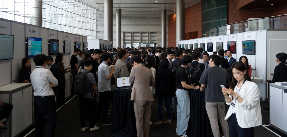 A bustling convention hall with numerous attendees networking and visiting booths, showcasing various technology companies.