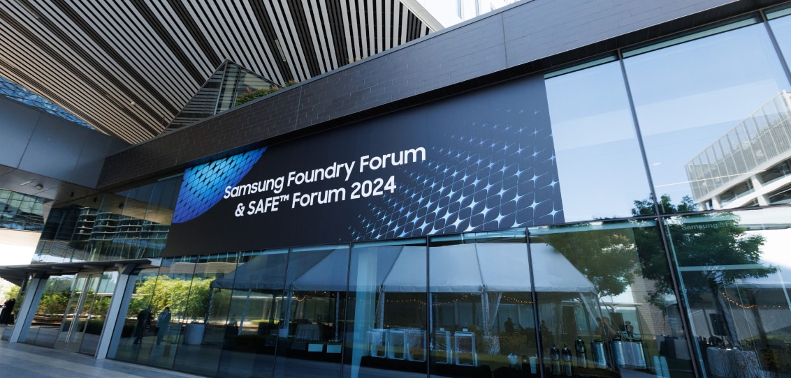 The entrance of a modern building featuring a banner for the Samsung Foundry Forum & SAFE™ Forum 2024