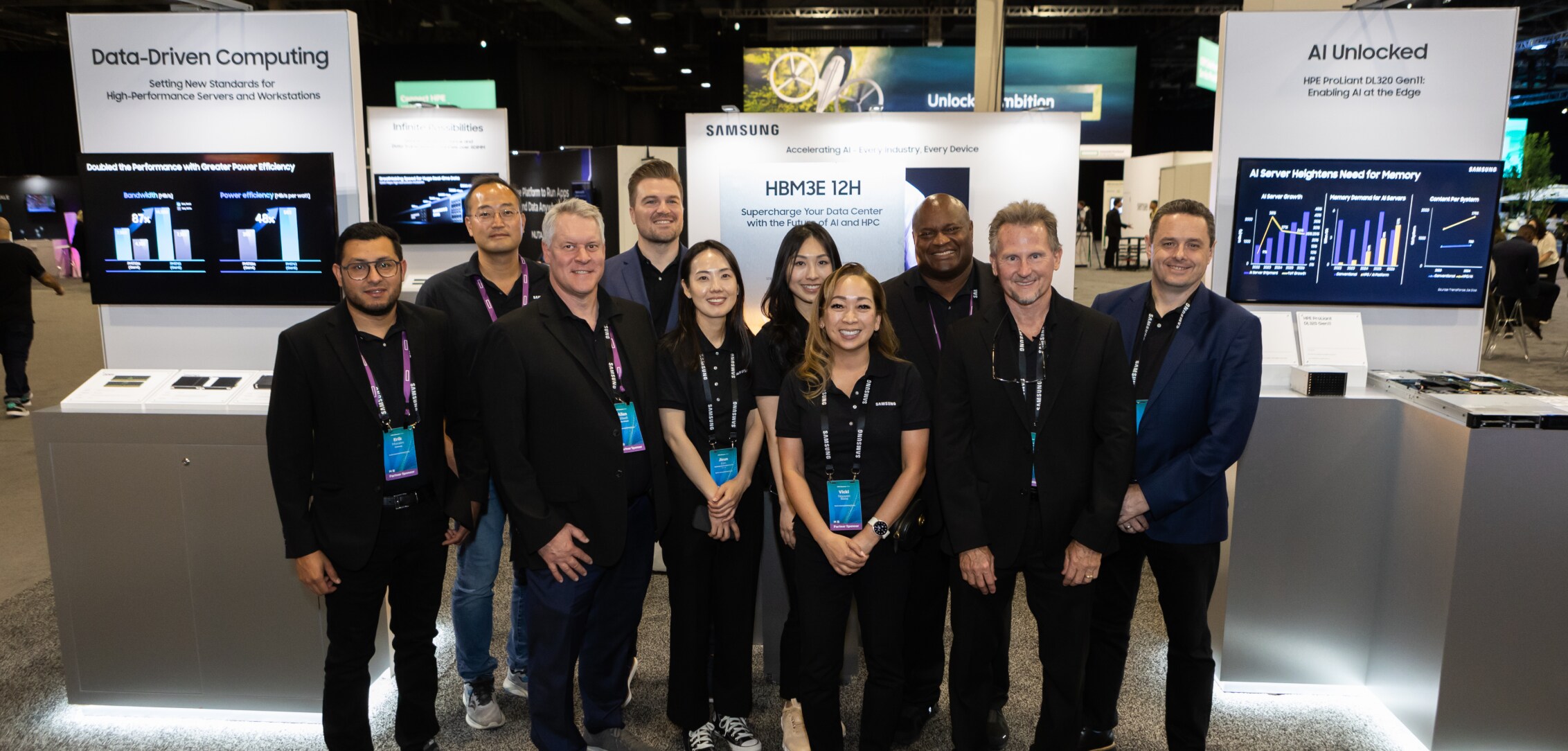 A group of Samsung team members posing in front of their Data-Driven Computing and AI Unlocked exhibits at HPE Discover 2024.
