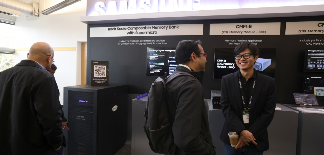 Attendees engaging in conversation at MEMCON 2024 booth about Rack Scale Composable Memory Bank with Supermicro.