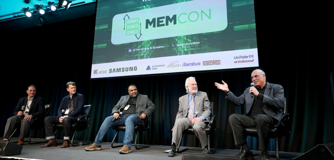 Panel discussion at MEMCON 2024 with five speakers on stage and the event logo on the screen in the background.
