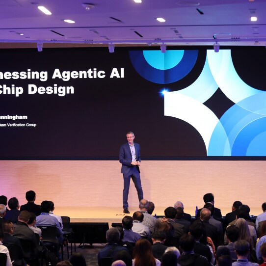 A speaker presents on 'Harnessing Agentic AI in Chip Design' at the SAFE™ Forum 2025.