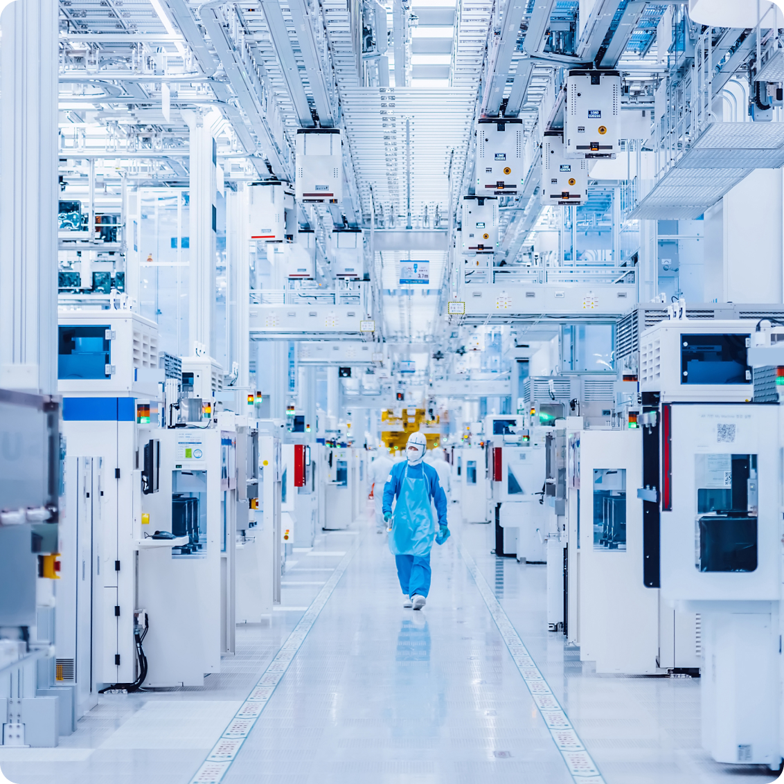 A wide-angle view of a modern cleanroom in a semiconductor manufacturing facility.