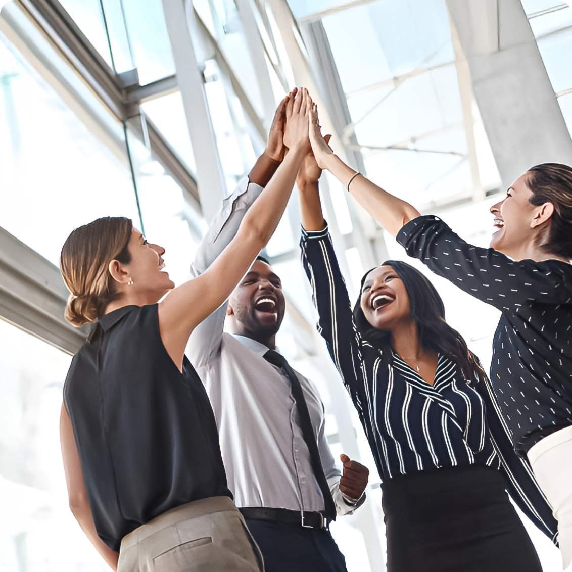 A group of professionals celebrating teamwork with a high-five.