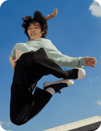 a young man is jumping up to the sky.