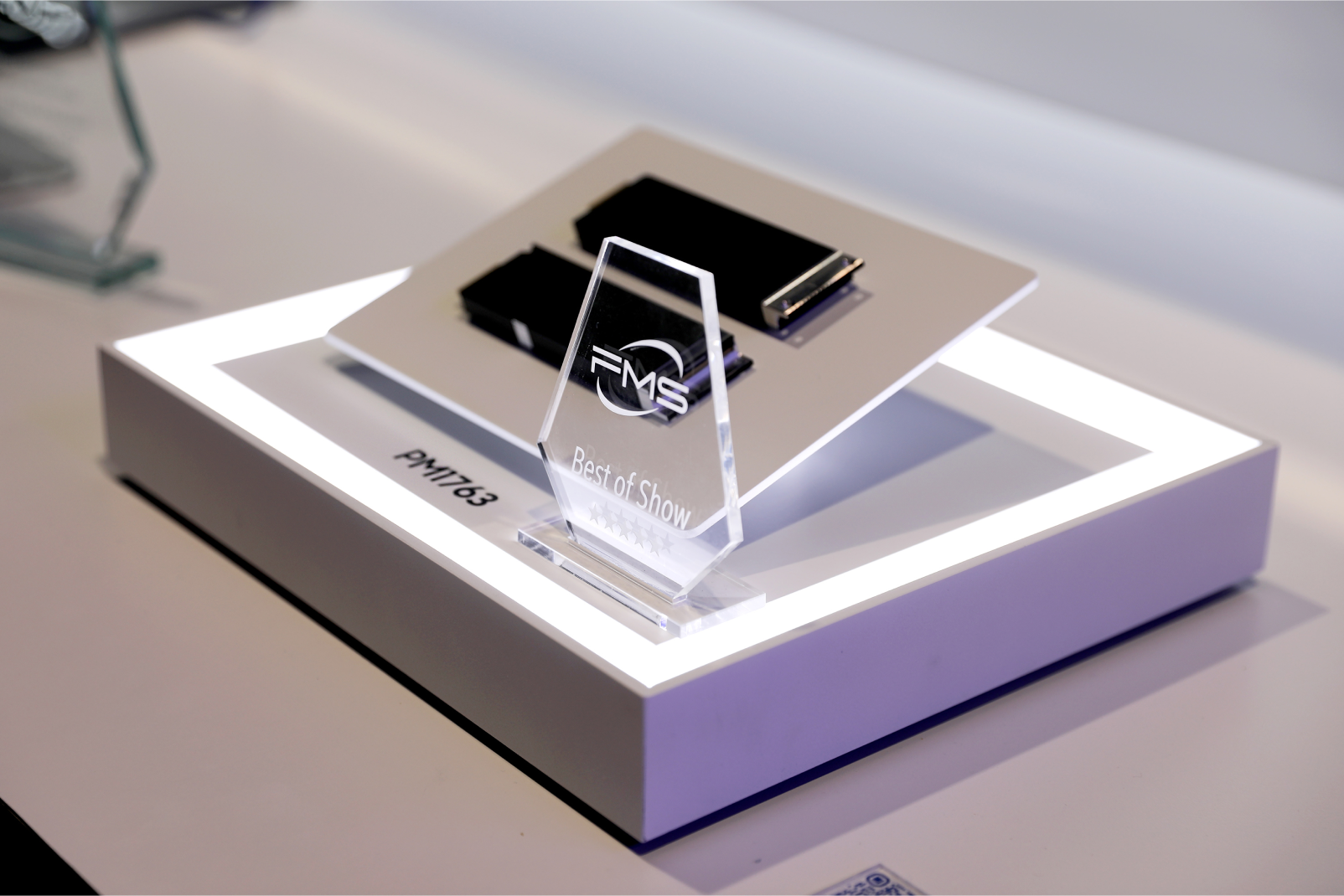 Close-up of Samsung PM1763 PCIe 6.0 SSD on display at FMS 2025, showcased with the Best of Show award trophy for most innovative memory technology.