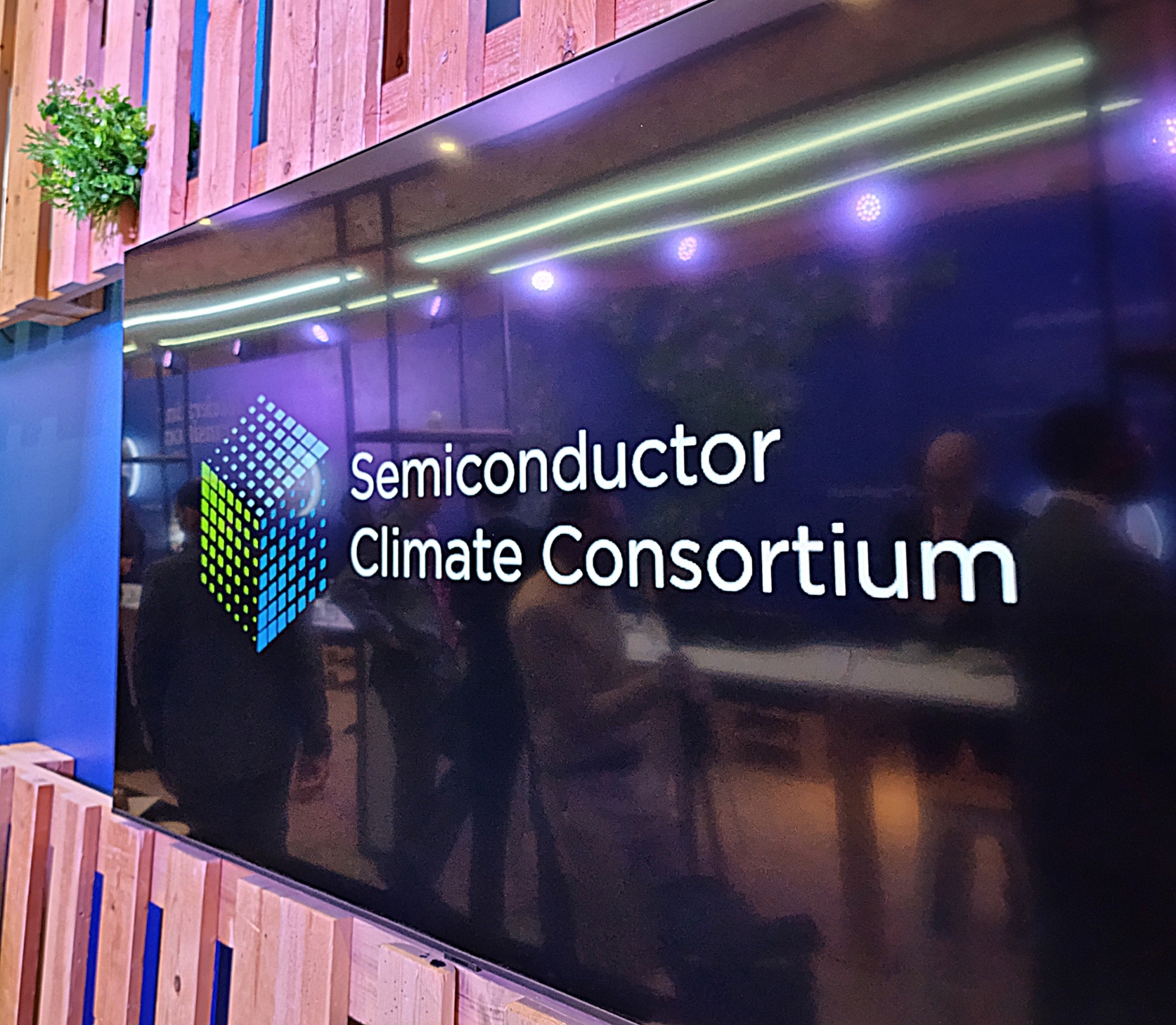 This is an image of a semiconductor climate consortium on a TV screen.