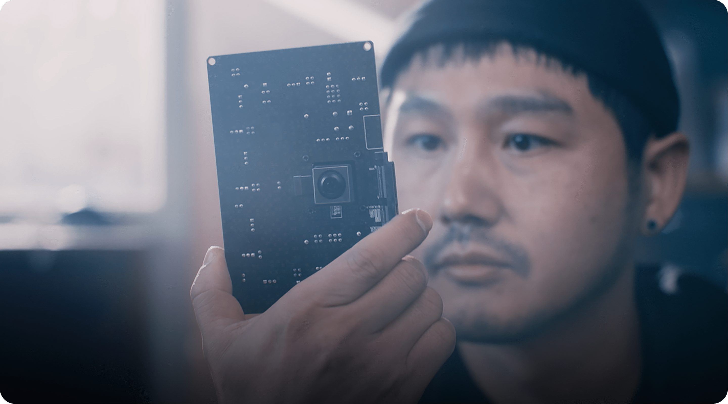 A man looking at a 200 megapixel Samsung ISOCELL image sensor.