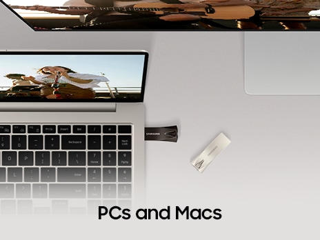 There is a BAR Plus plugged into the laptop, and one more is placed next to it. A PC monitor is also visible, and it says 'PCs and Macs'