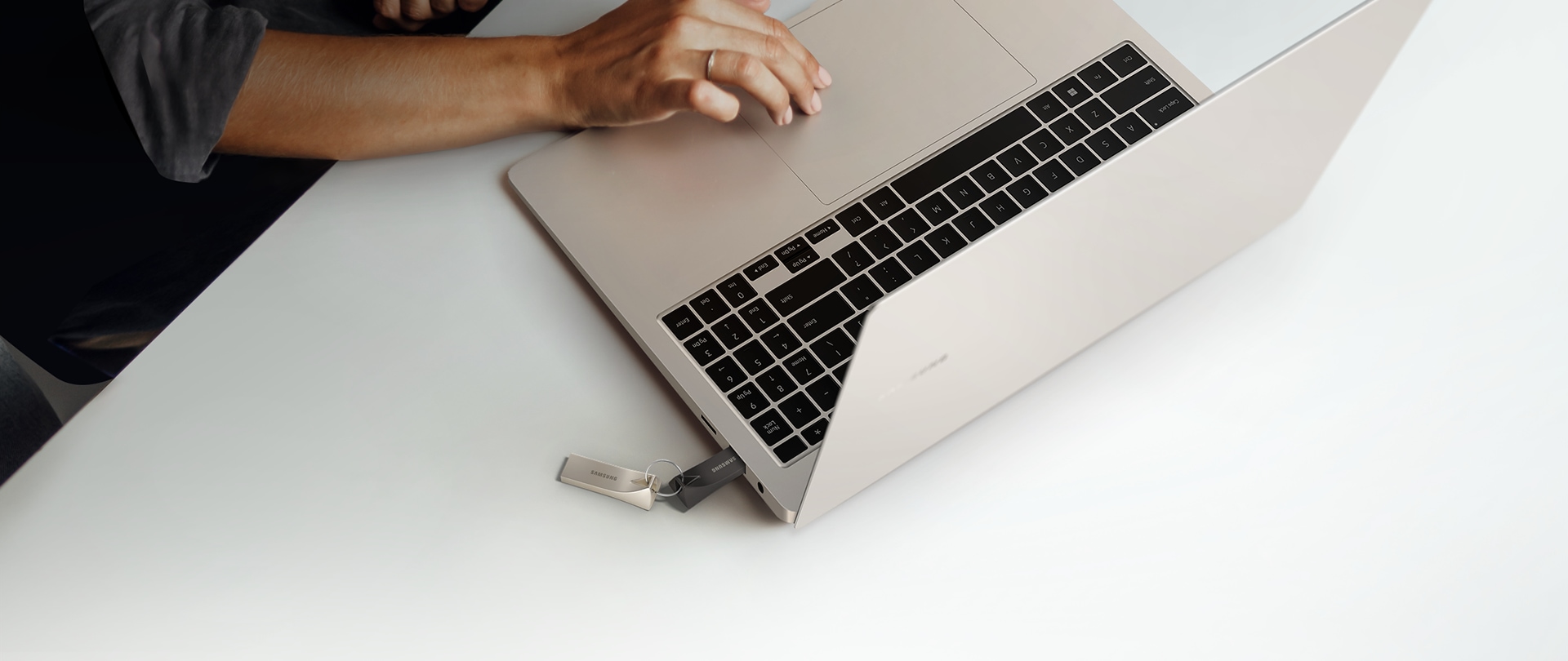The BAR Plus is plugged into the laptop, and one more is connected via a key ring.