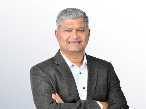 Professional portrait of Rajesh Krishnan, Managing Director of SSIR, wearing a blazer with his arms crossed.