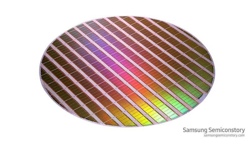 Image of a wafer that has undergone several stages of physical and chemical processing to form an IC on the surface.