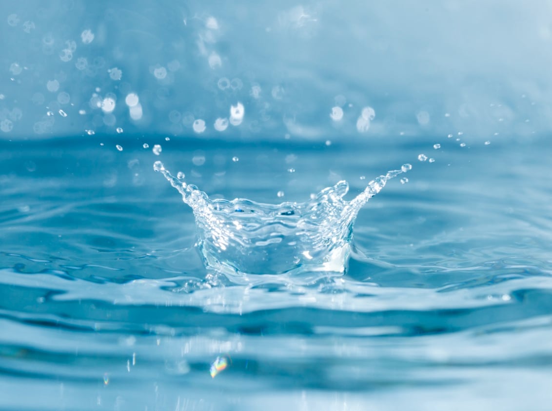 A scene capturing the ripples created on water by water droplets splashing