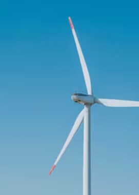 A wind turbine against a blue sky