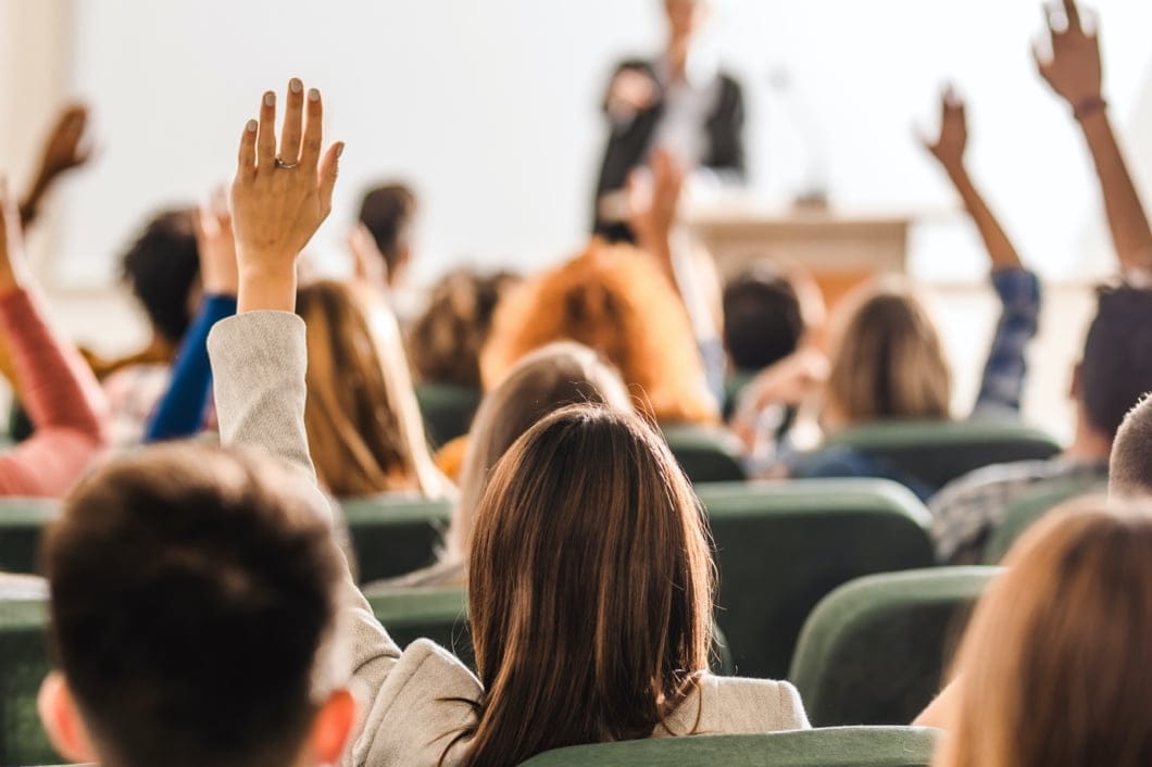 Multiple hands raised to answer questions.