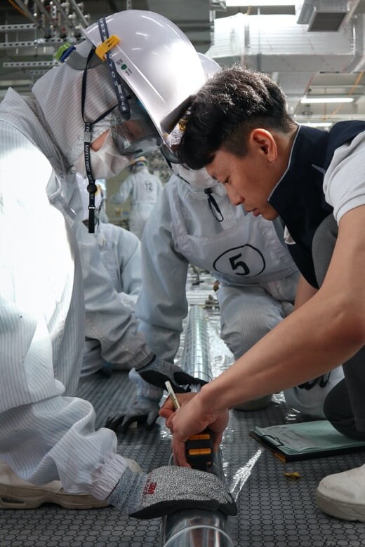 Partner company employees are performing maintenance on pipes.