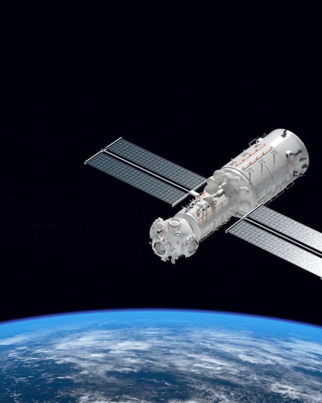 Satellite floats in space above Earth.