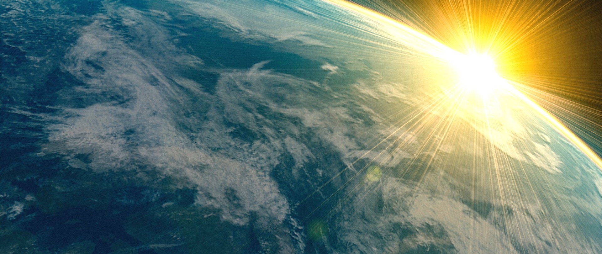 Close-up of Earth in space with the sun in the background.