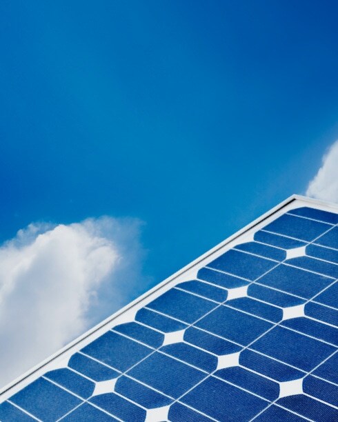 Close-up of solar panel against a blue sky.